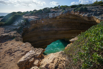 Benagil cave from above with view at the atlantic coast near Lagoa town, Algarve, Portugal.