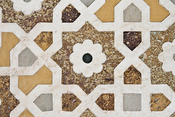 Agra, Uttar Pradesh / India - February 27, 2012 : An inlaid work of colorful marble stones on the wall of the Tomb of the Itimad-Ud-Daulah (Baby Taj).