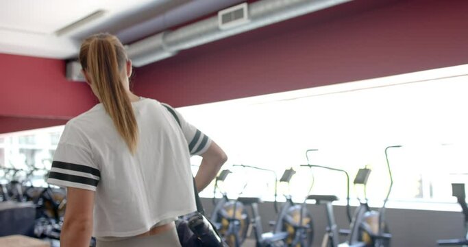 Young Caucasian woman at the gym, with copy space