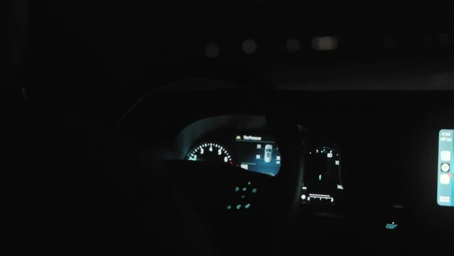 Closeup of car dashboard instruments speedometer at night
