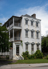 Old house with front porch and multiple balconies in Charleston, Boston