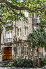 Fototapeta na wymiar Historic stone building in Charleston, South Carolina surrounded by lush greenery