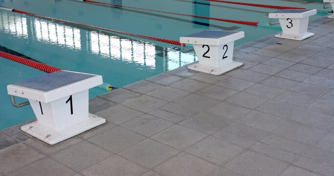 Starting blocks at the edge of a swimming pool, ready for a race