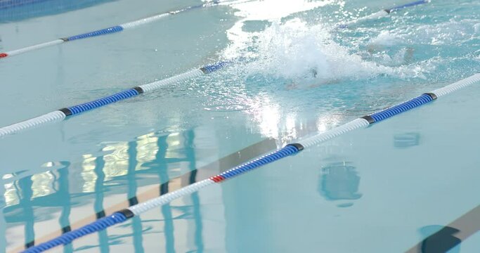 Swimmer in action at a pool, with copy space