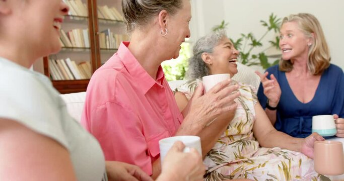 Senior diverse group of women share a laugh at home