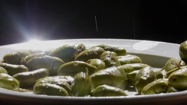 table olives falling into a white plate