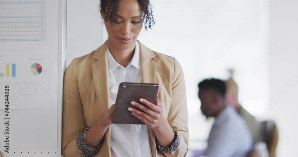 Wall mural Image of icons and data processing over biracial businesswoman in office