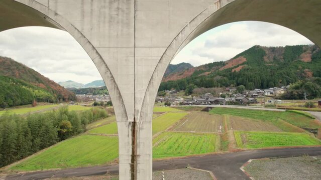 Aerial Drone Fly near geometrical cemented bridge at Japanese countryside road, in Asago Hyogo, Countryside Japan Village, agricultural feel