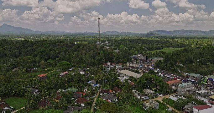 Ibbagamuwa Sri Lanka Aerial v2 drone flyover village town captures local community along Dambulla road, surrounded by lush jungle, mountains, and farming fields - Shot with Mavic 3 Cine - April 2023