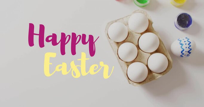 Animation of happy easter text over easter eggs and paints on white background