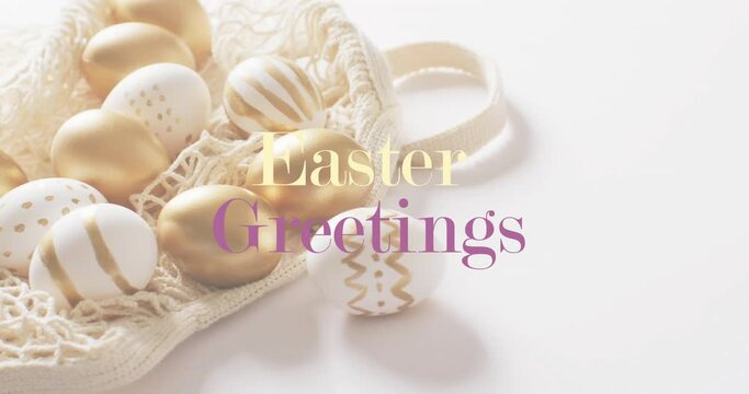 Animation of easter greetings text over white and gold easter eggs on white background