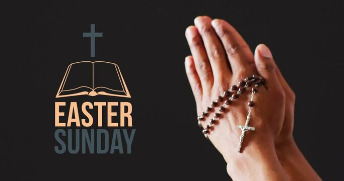 Animation of easter sunday text over biracial woman's praying hands with rosary on black background