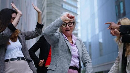 Group of excited business women diverse ages dancing outside the office center having fun enjoying and celebrating success at work. Female people entrepreneur and happy lifestyle concept. Slow motion  - Powered by Adobe