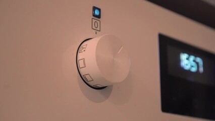 Oven control knob pops out of panel and oven setting adjusted, closeup
