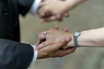 Couple holding hands, with a wristwatch and a diamond ring