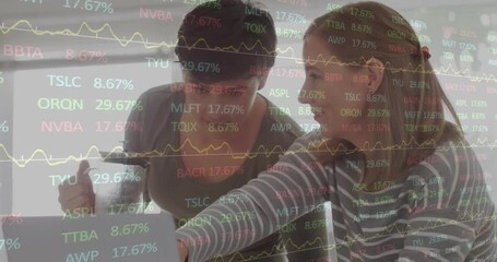 Animation of financial data processing over happy caucasian lesbian couple using laptop at home - Powered by Adobe