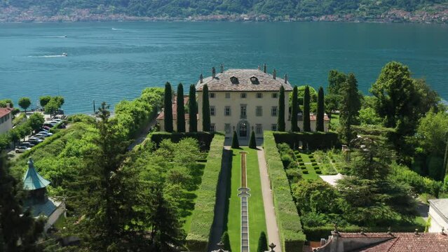 Villa balbiano, lush gardens, and lake como on a sunny day, aerial view