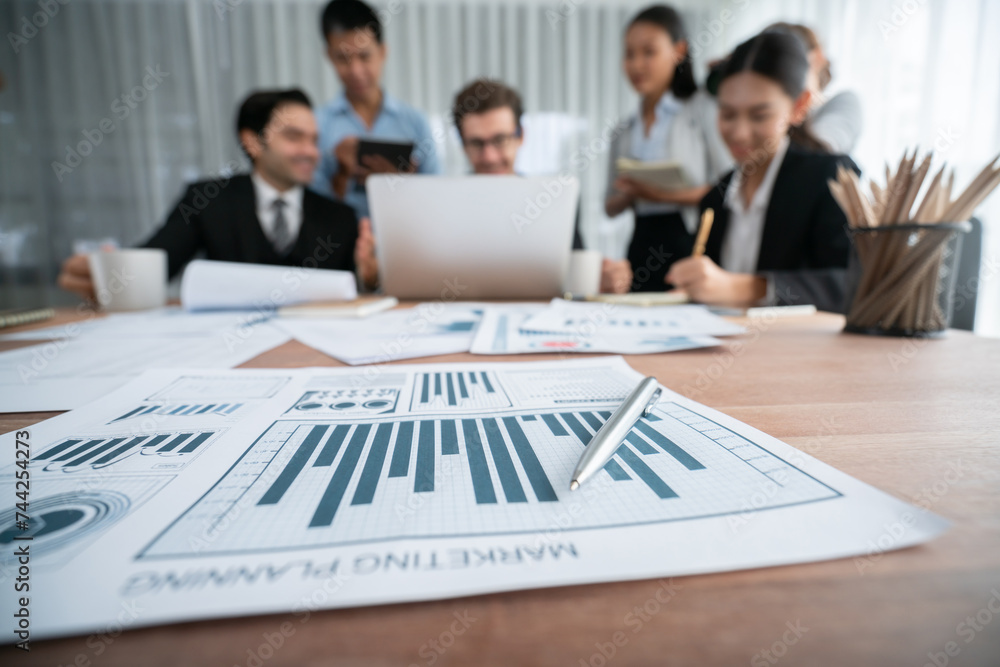 Aufkleber piles of analyzed financial data dashboard on meeting table with background of business people analy