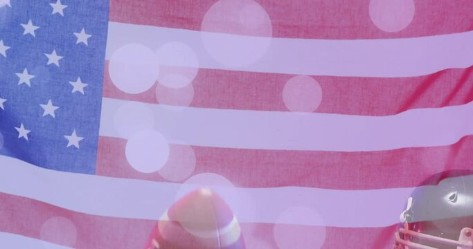 Animation of caucasian american football player holding ball and flag of usa