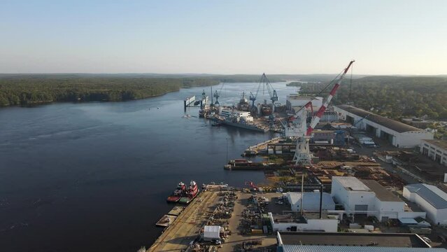 Descending aerial shot of the empty dry dock at the Bath Iron Works, showing the River Kennebec, Clear day