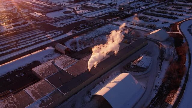 Gorgeous sunset with rays illuminating the power plant steam