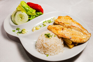 Chicken fillet with rice, vegetable salad, and avocado. Healthy meal