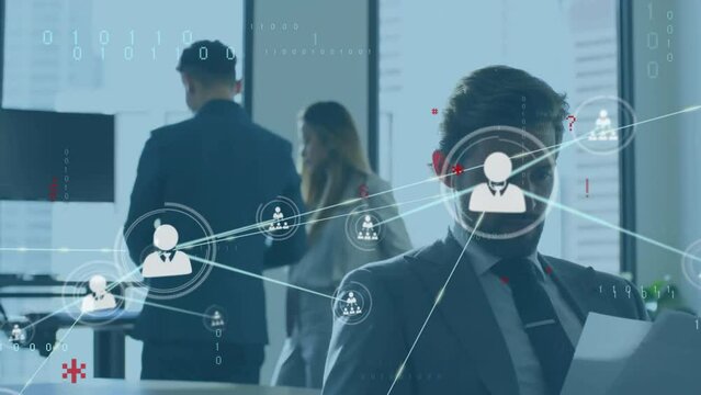 Animation of network of connections with icons over caucasian businessman in office