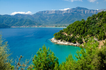 Fototapeta na wymiar Scenic view of vibrant blue waters with distant mountains in Thassos, Greece