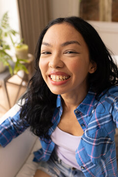 Young biracial woman smiles brightly