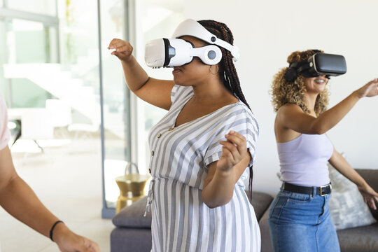 Young biracial women enjoy virtual reality at home