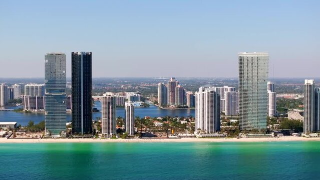 Side aerial video highrise beachfront realty Sunny Isles Beach in Miami Florida 4k 2024