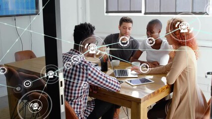 Animation of network of connections with icons over diverse business people talking in office - Powered by Adobe