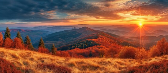 A stunning autumn sunset view amidst the breathtaking Beskidy mountains, showcasing a painting of a sunset over a mountain range.