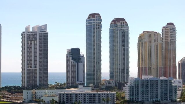 Aerial drone parallax stock footage Sunny Isles Beach highrise towers 2024