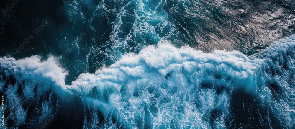 Poster this aerial photo captures the view from above of a vast expanse of ocean, with waves crashing and f