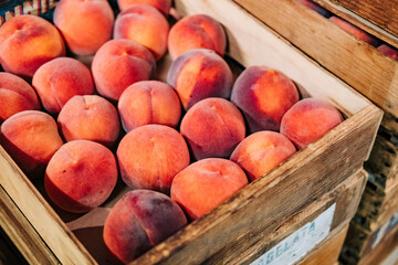 Ripe Bounty: Antique Wooden Crate Overflowing with Perfectly Ripened Peaches