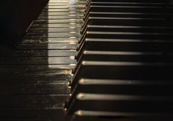 Piano keys side view with shallow depth of field. Classic grand piano keyboard background, Copy...