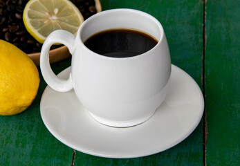Hot black coffee lemon in white cup.