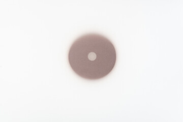 isolated round wooden ring on a lighted surface with tracing paper on top