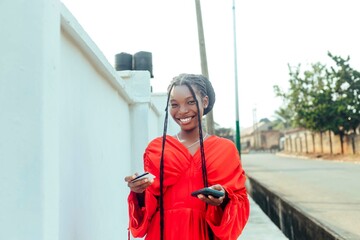 happy woman with bank card holding mobile phone 