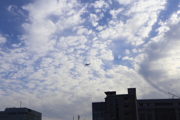 Airplane flying in a cloudy sky