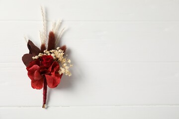Beautiful boutonniere on white background, top view. Space for text - obrazy, fototapety, plakaty
