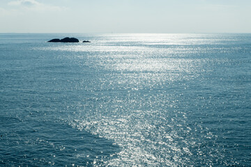 Seascape with rocks and horizon on a sunny day