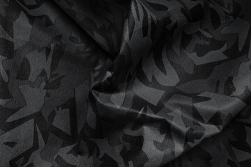 Texture of crumpled camouflage fabric as background, top view. Black and white effect