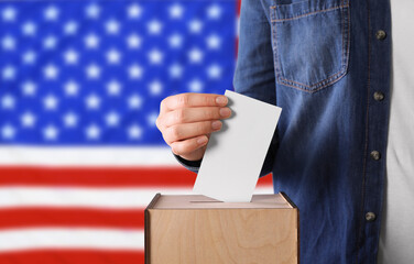 Election in USA. Woman putting her vote into ballot box against national flag of United States,...
