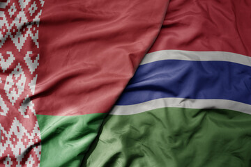 big waving national colorful flag of gambia and national flag of belarus.