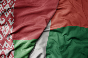 big waving national colorful flag of madagascar and national flag of belarus.
