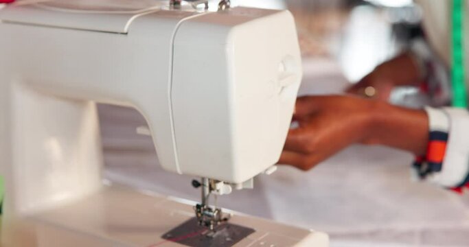 Hands, sewing machine and woman with cotton in workshop for manufacturing with fabric. Small business, creative and closeup of seamstress with equipment, thread and textile for fashion production.