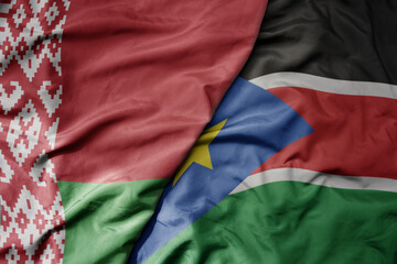 big waving national colorful flag of south sudan and national flag of belarus.