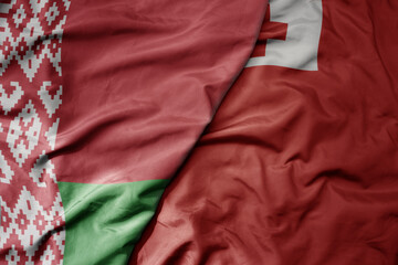 big waving national colorful flag of Tonga and national flag of belarus.